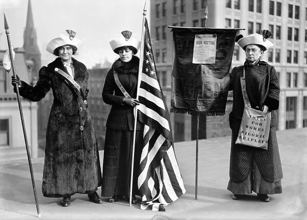 SUFFRAGETTES, c1910. Three women photographed on a Brooklyn rooftop before a demonstration for womens right to vote. One woman holds a poster for the Womens Suffrage Party announcing a mass meeting at the Brooklyn Academy of Music. Photograph, c1910