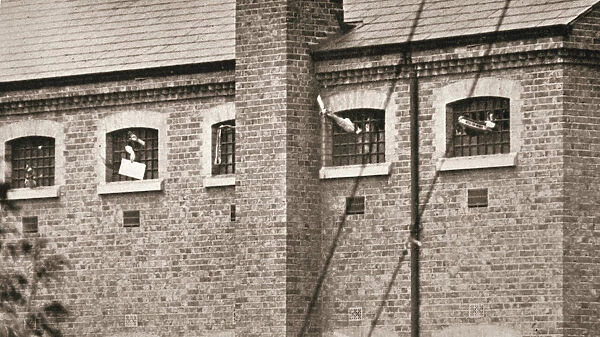 Hunger strikers waving to Christabel Pankhurst from their cells in Holloway Prison, London, 1909