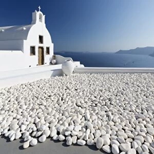 Small whitewashed church against blue sea and sky, Finikia, near Oia, Santorini, Cyclades