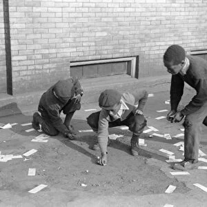 CHICAGO: MARBLES, 1941. A group of African American boys playing marbles outside in Chicago